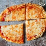 cheesy flatbread pizza on a gray background
