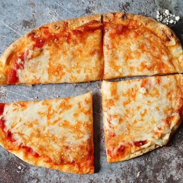 cheesy flatbread pizza on a gray background