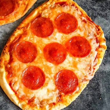 pepperoni flatbread pizza on a gray board