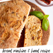 bread machine tomato basil bread cut into slices on a cutting board