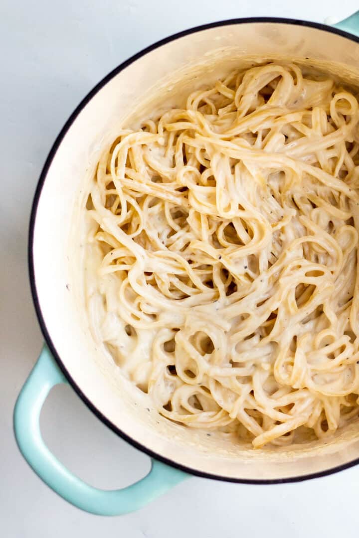 cream sauce tossed with spaghetti in a large pot