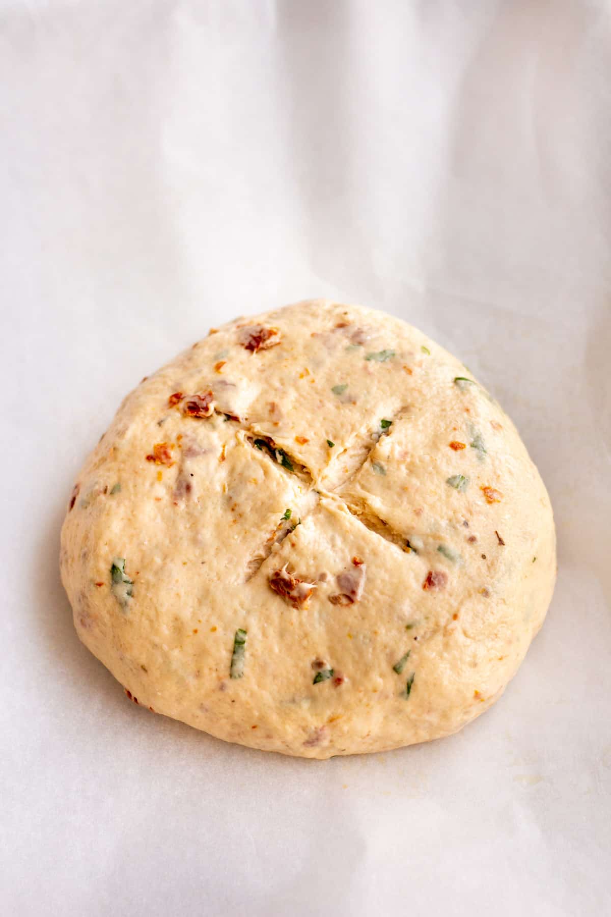 tomato basil dough ball on parchment paper