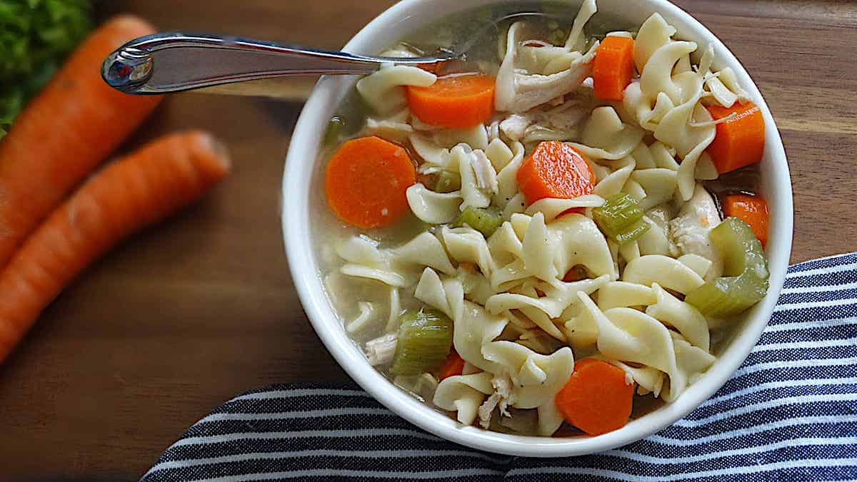 chicken noodle soup in a white bowl