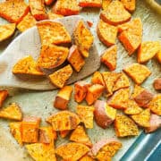 crispy roasted sweet potato cubes on a baking sheet
