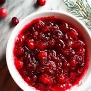 fresh cranberry sauce in a white bowl on a marble board