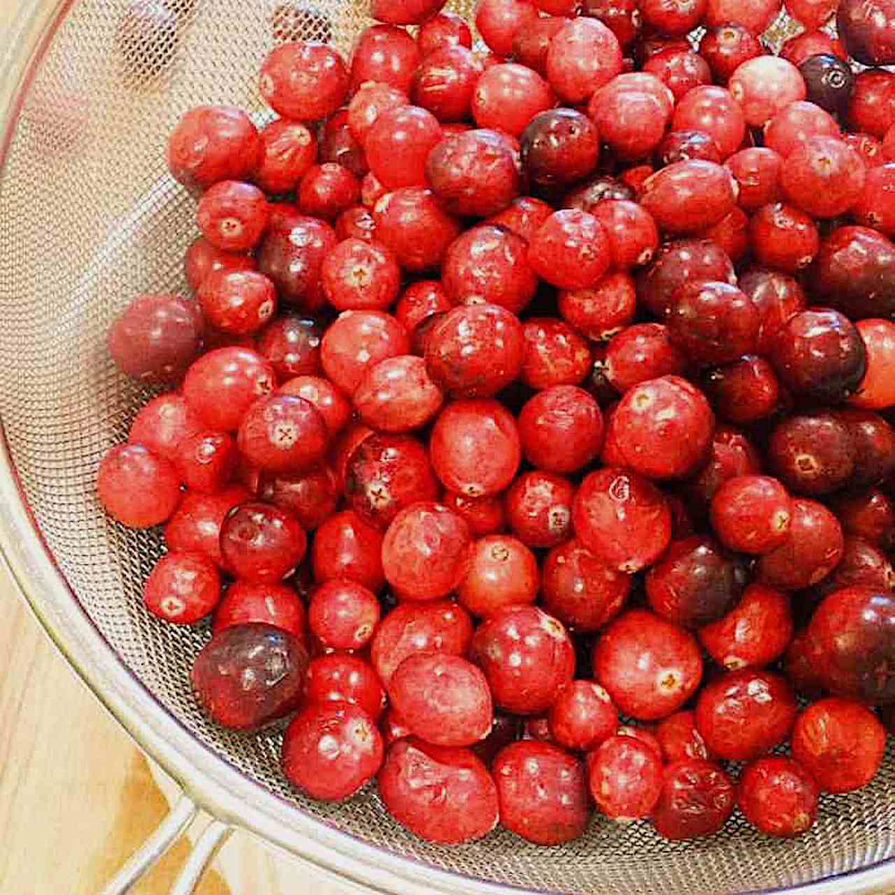 fresh cranberries in a strainer