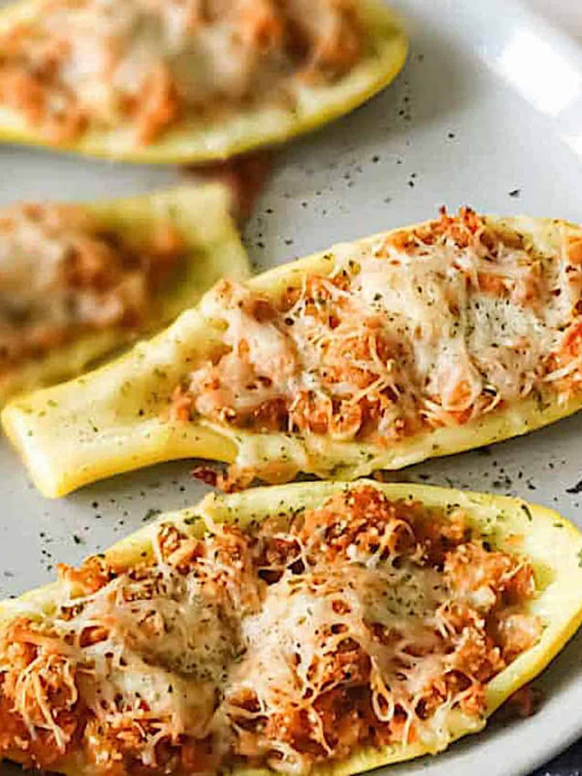 stuffed yellow squash boats on a serving platter