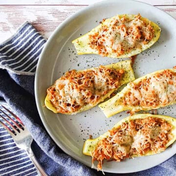 stuffed yellow squash boats on a serving platter