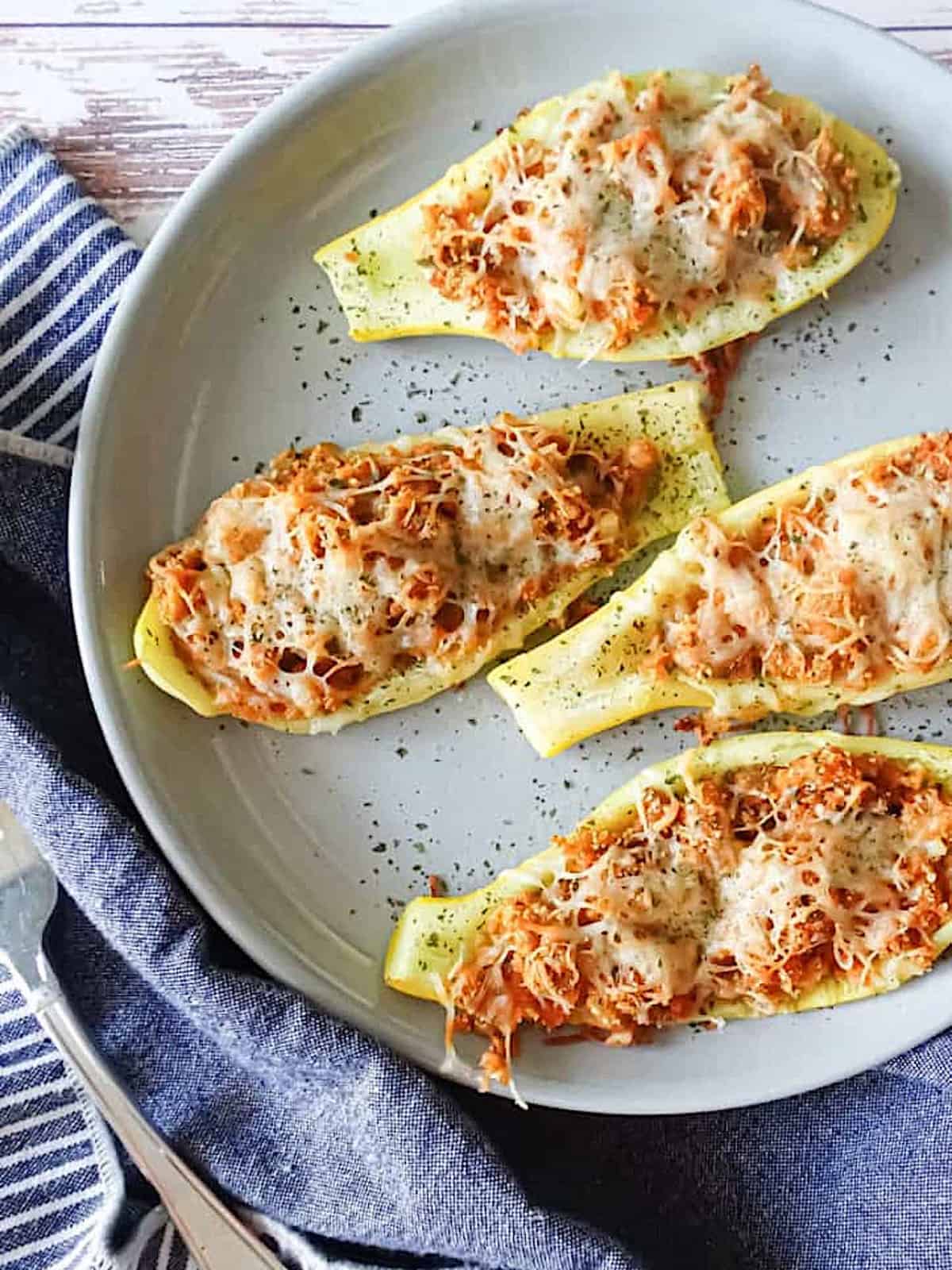 stuffed yellow squash boats on a serving platter