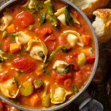 tortellini soup with spinach in a soup bowl