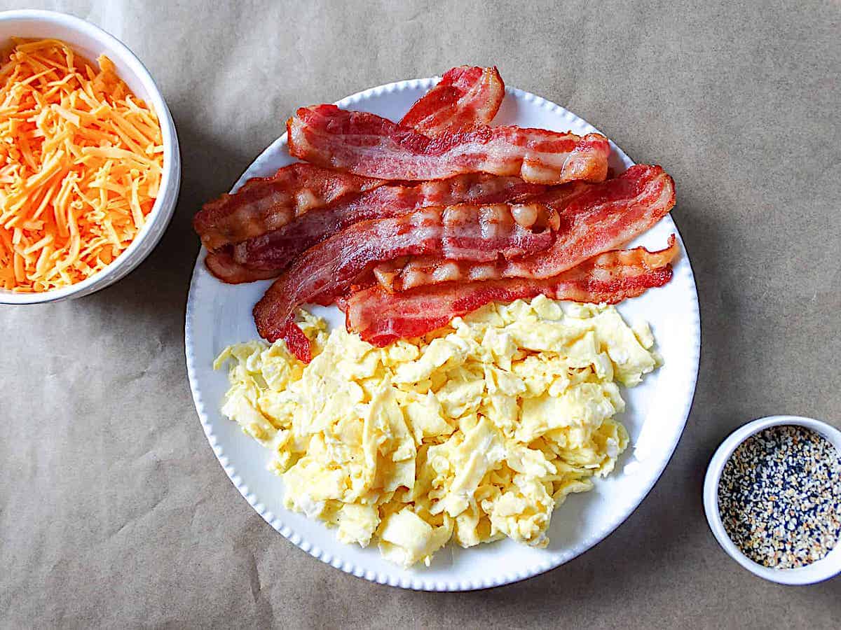 bacon and scrambled eggs on a white plate