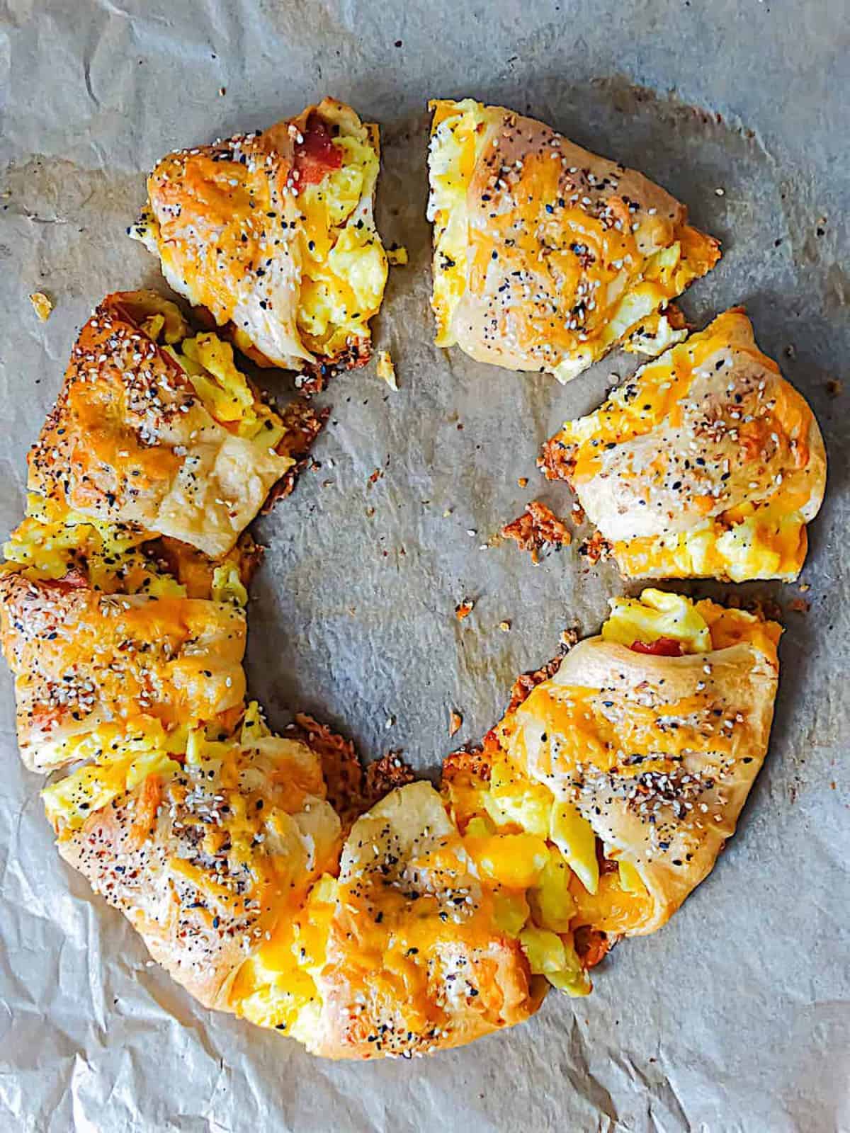 breakfast crescent ring with bacon, egg and cheese on parchment paper