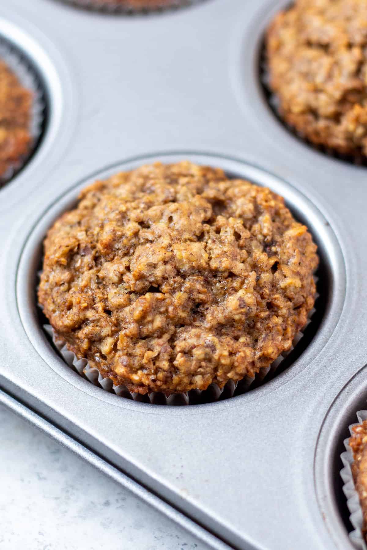 one flaxseed muffin in a baking tin