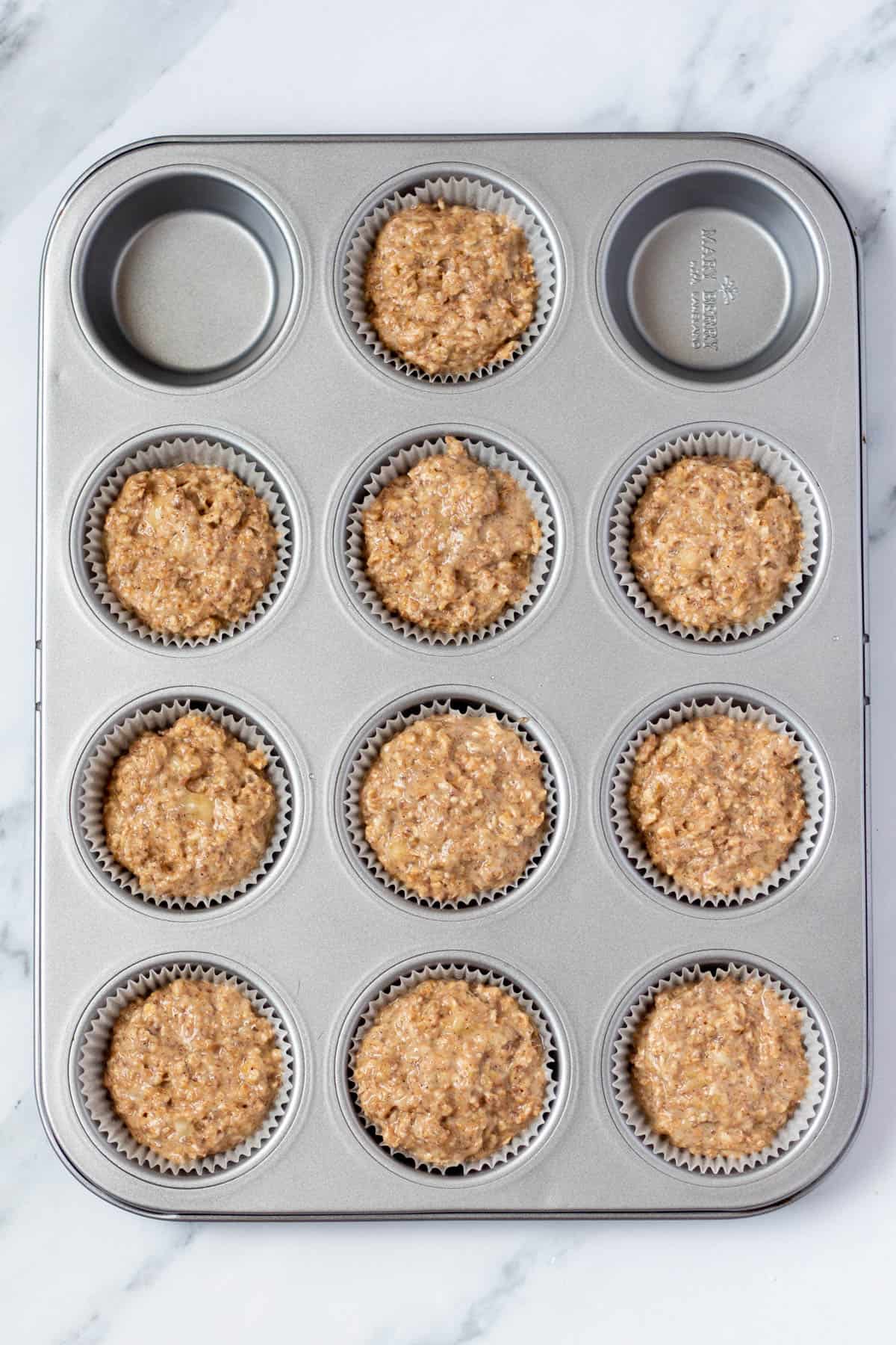 uncooked flaxseed muffins in a muffin tin