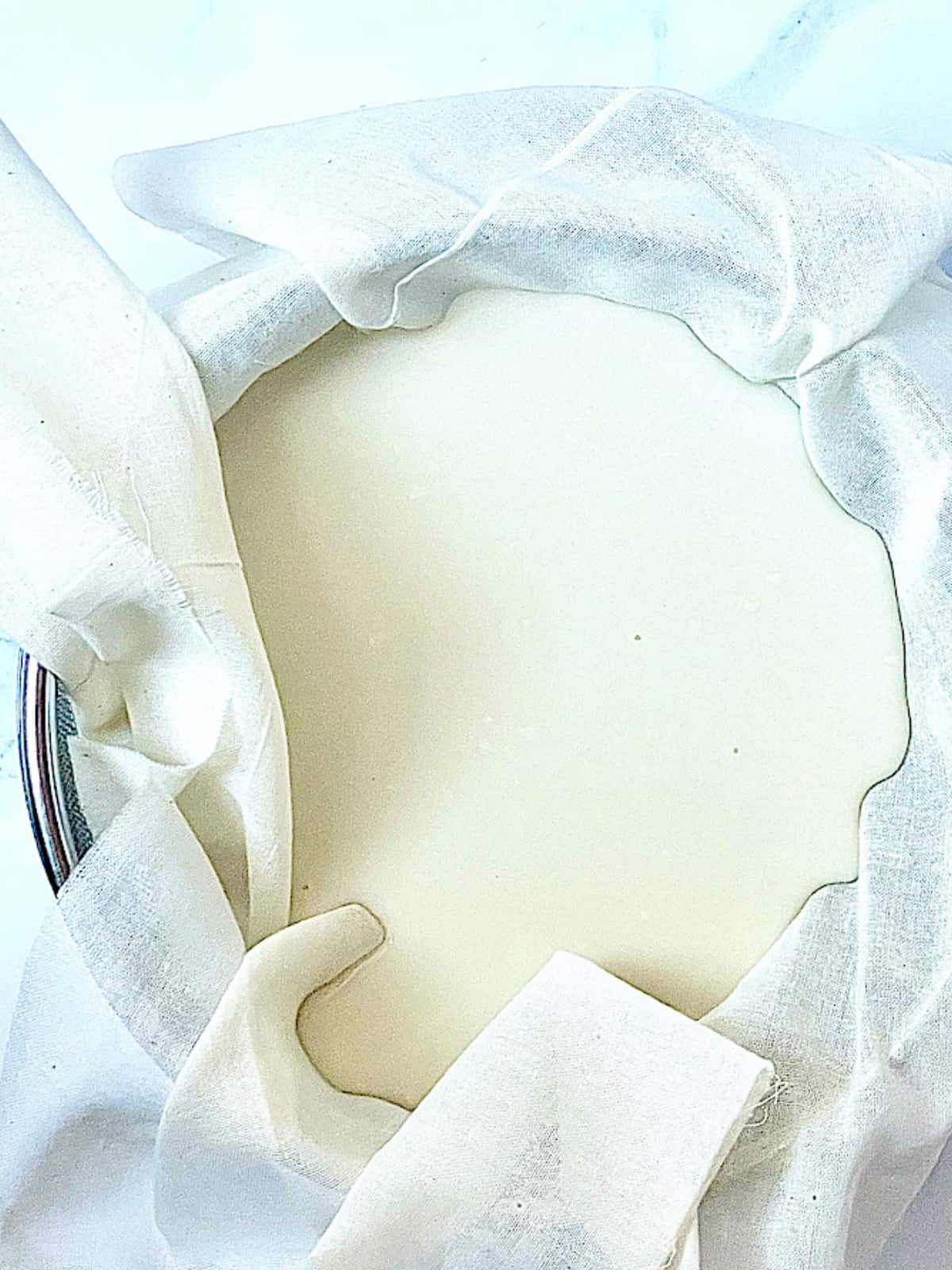 yogurt straining in a cheesecloth