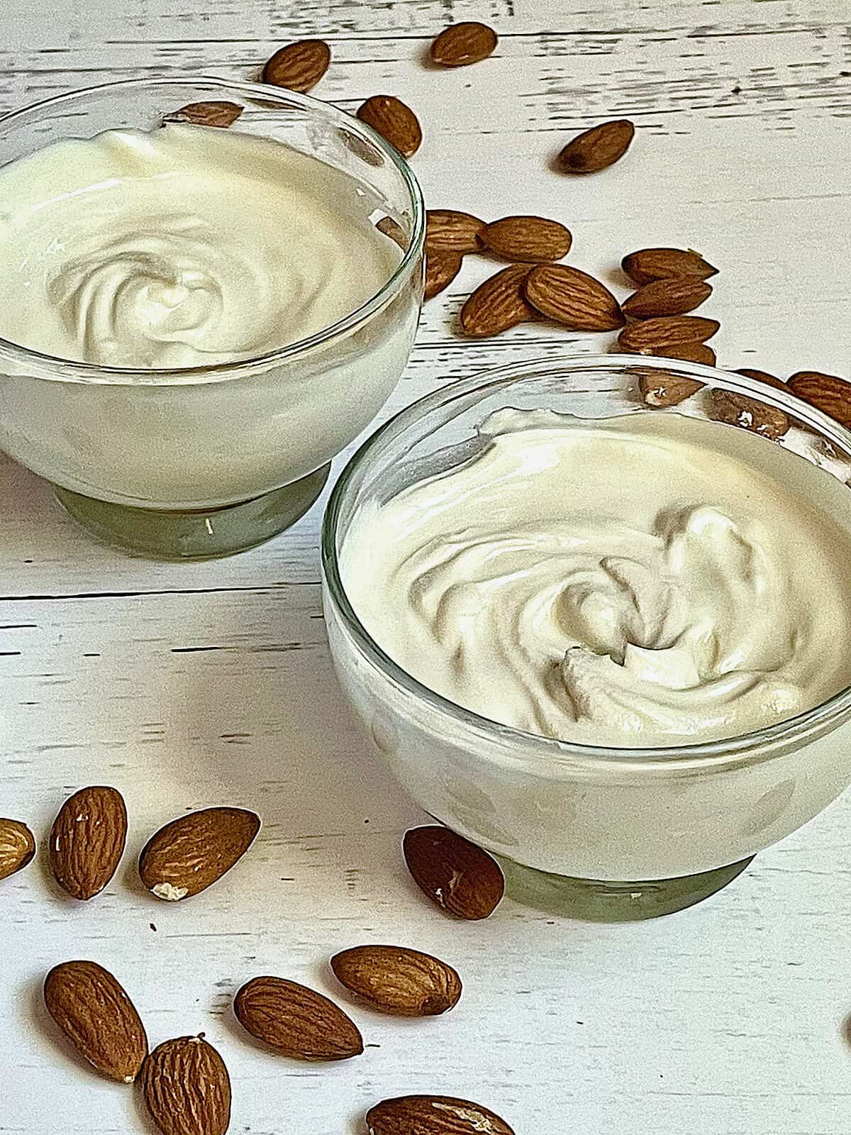 creamy Greek yogurt in serving bowls topped with almonds
