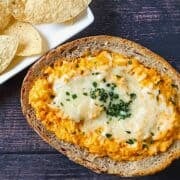 buffalo cauliflower dip in a bread bowl