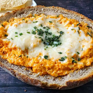 stovetop buffalo cauliflower dip in a bread bowl