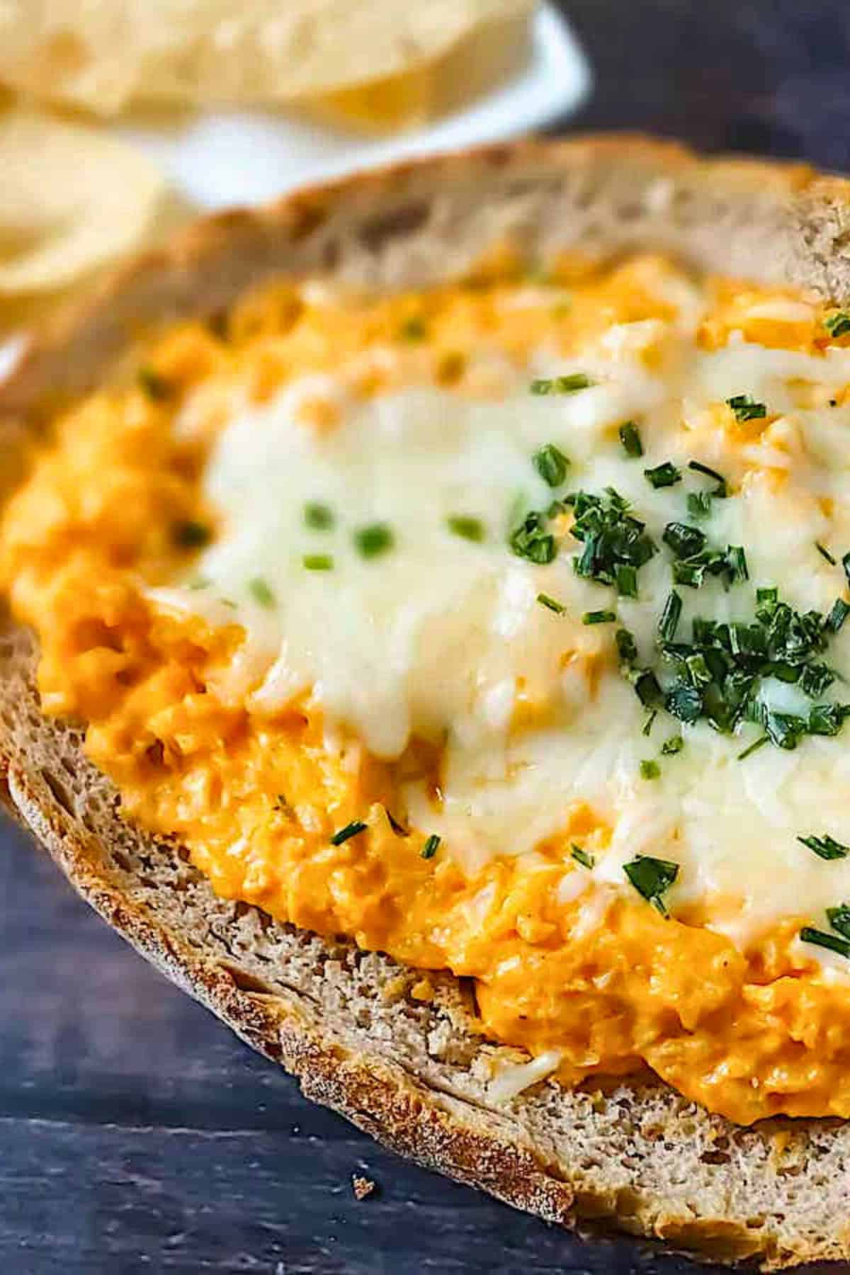 vegetarian buffalo cauliflower dip in a bread bowl