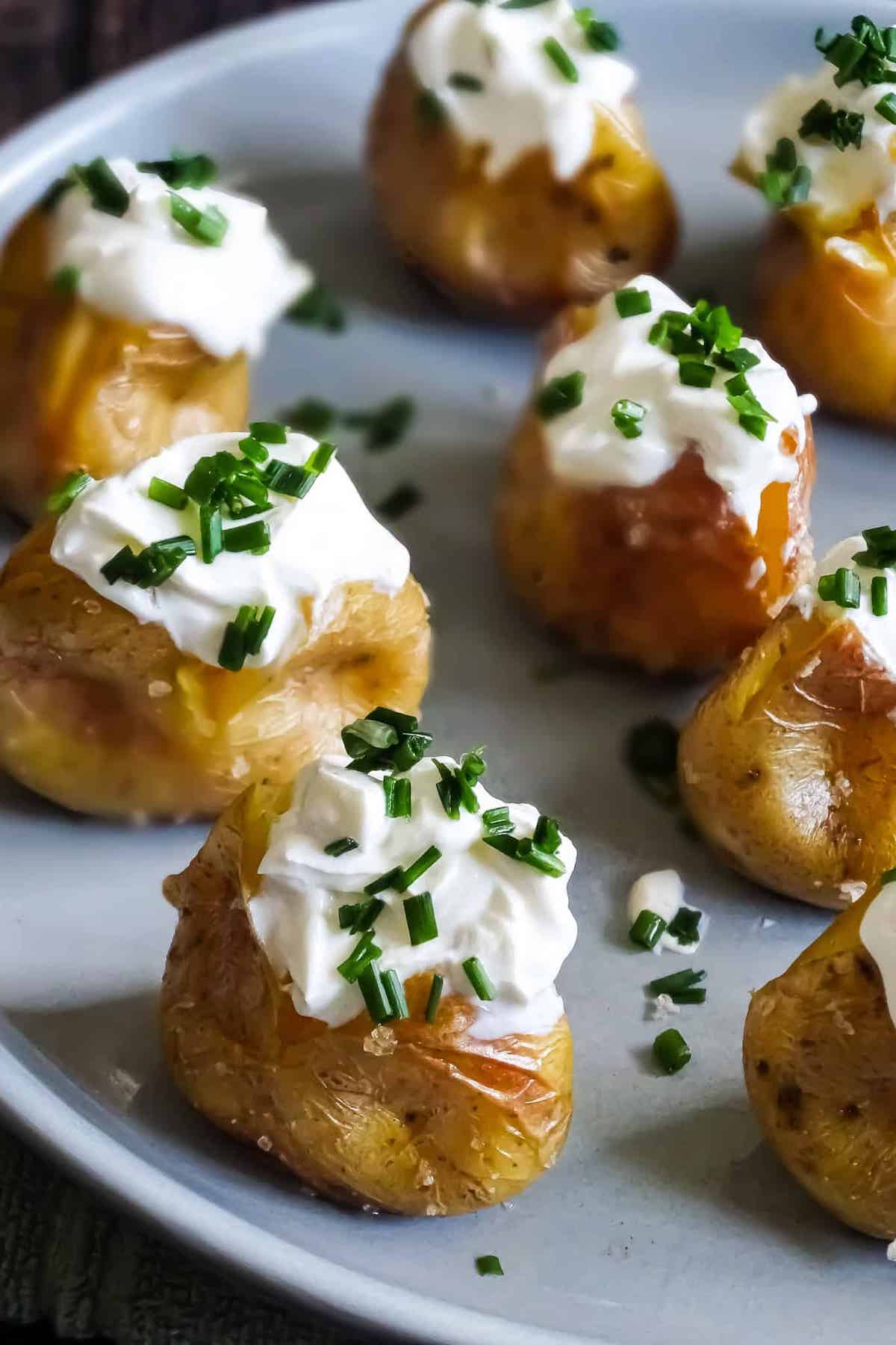 close up of mini potatoes with sour cream and chives