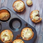 strawberry cheesecake muffins in a jumbo muffin win with wooden background