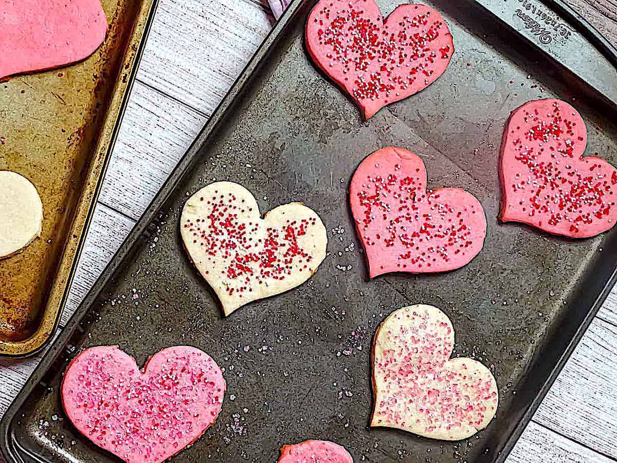 heart shaped butter cookies on a baking sheet 