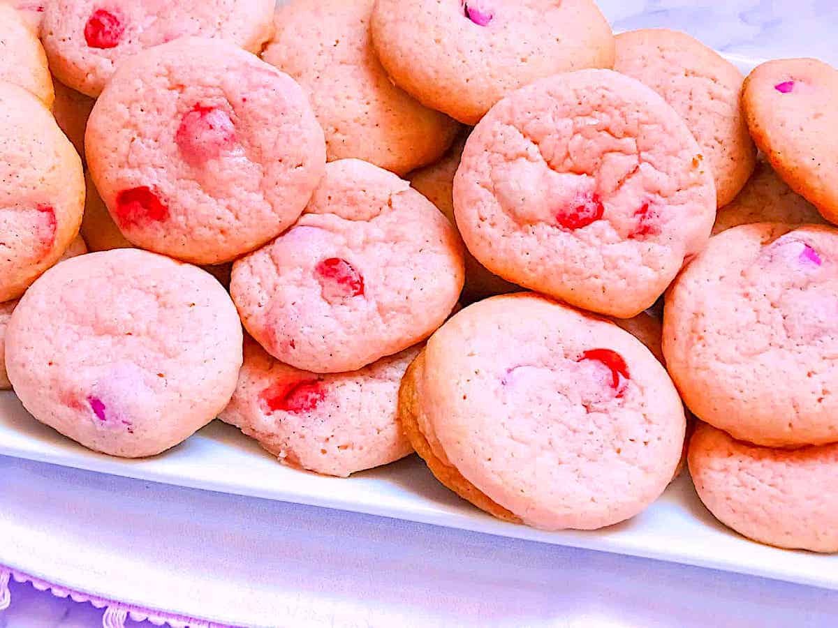 soft pink sugar cookies on a white plate
