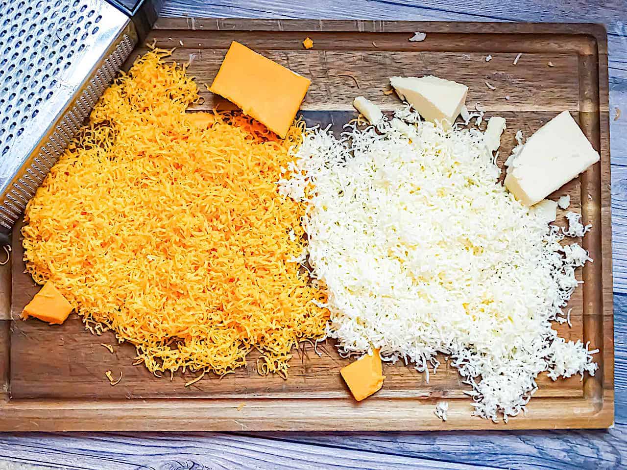 shredded cheddar cheese on a cutting board