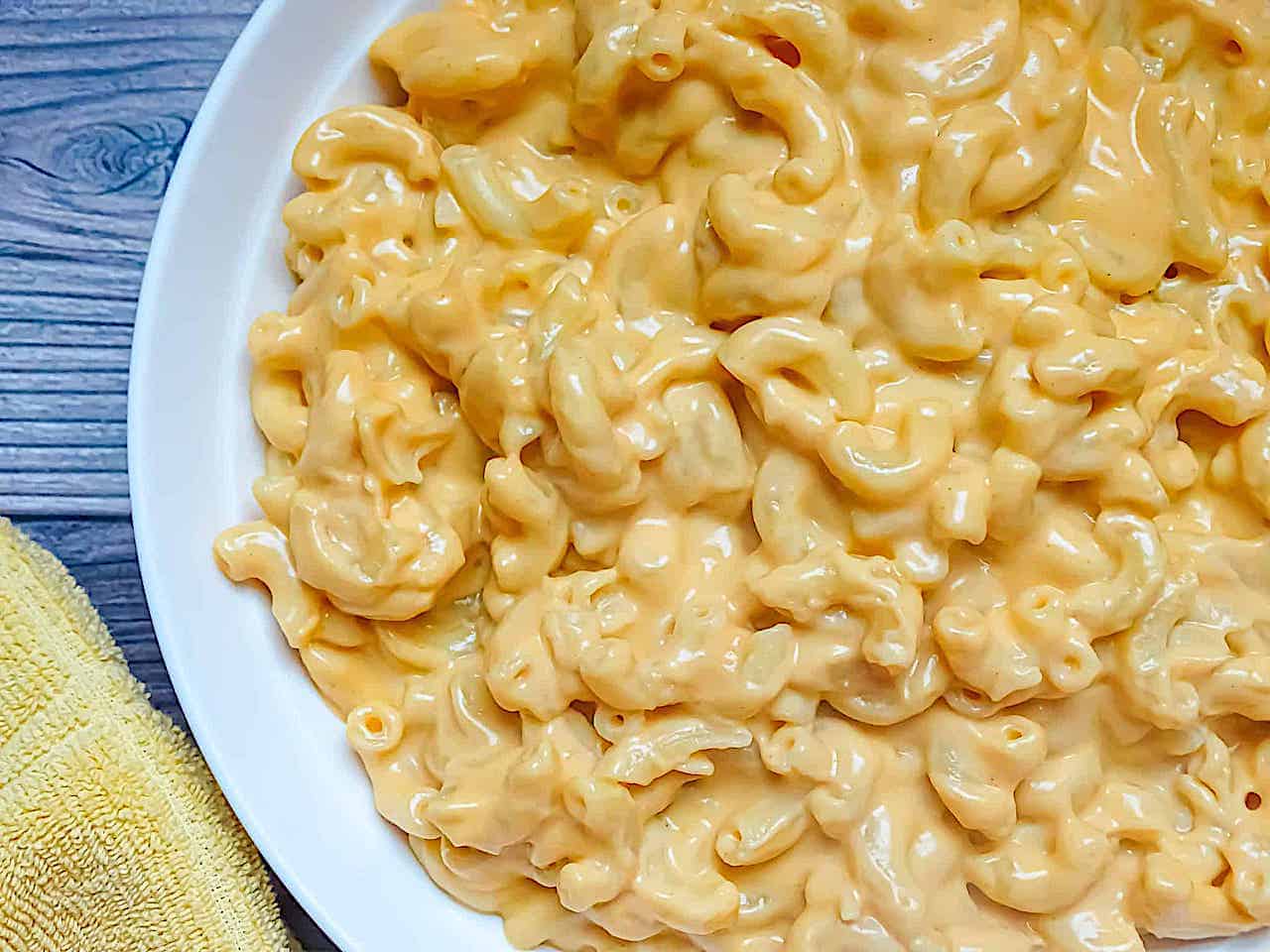 creamy homemade mac and cheese in a white plate 