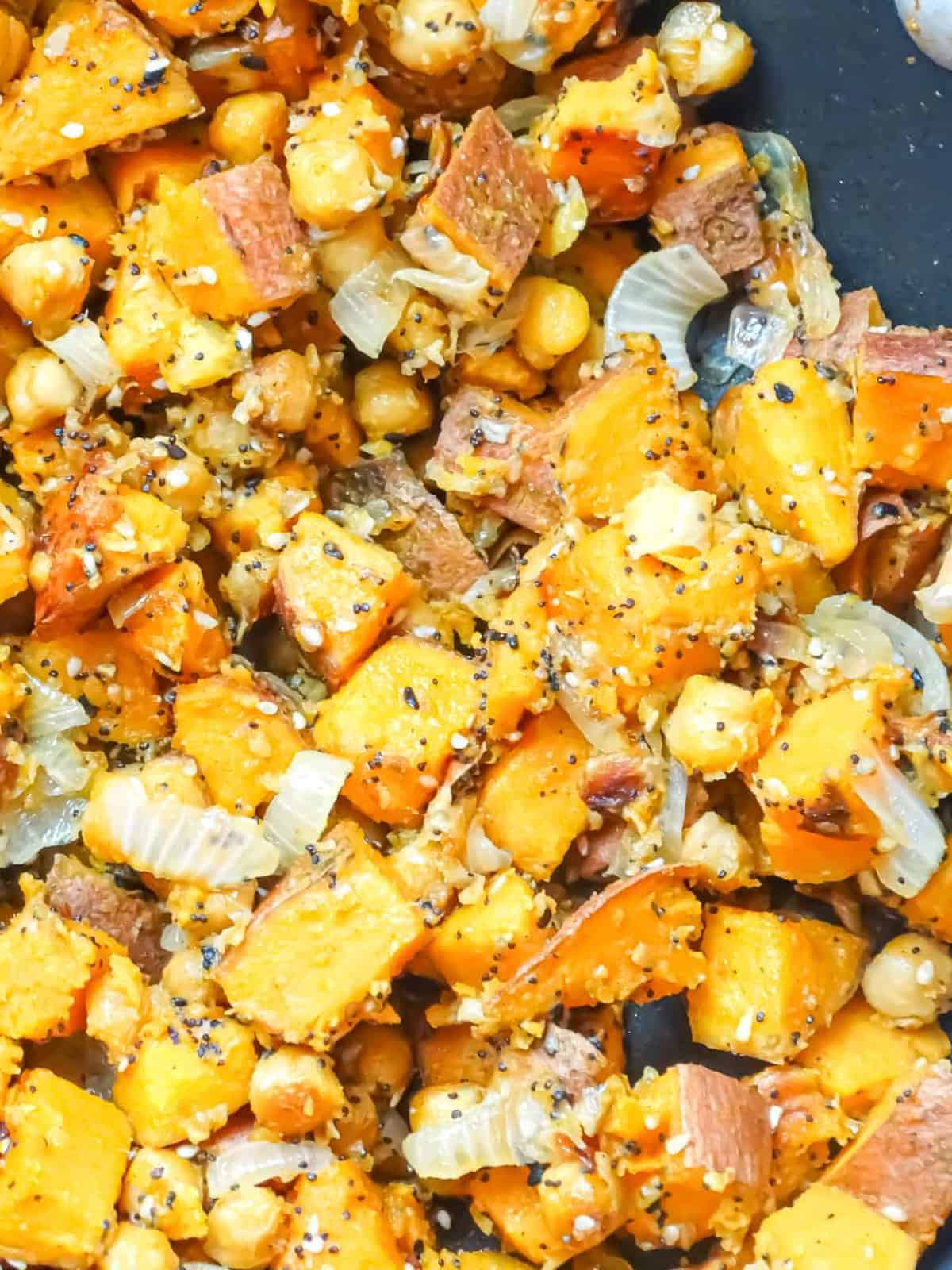 sweet potatoes, onions and everything bagel seasoning in a wok