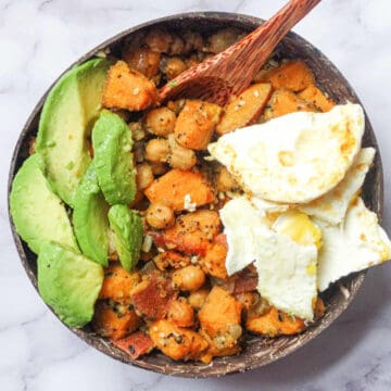 sweet potato chickpea hash bowl topped with egg and avocado