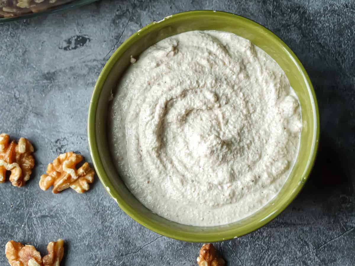 walnut cream sauce in a green bowl