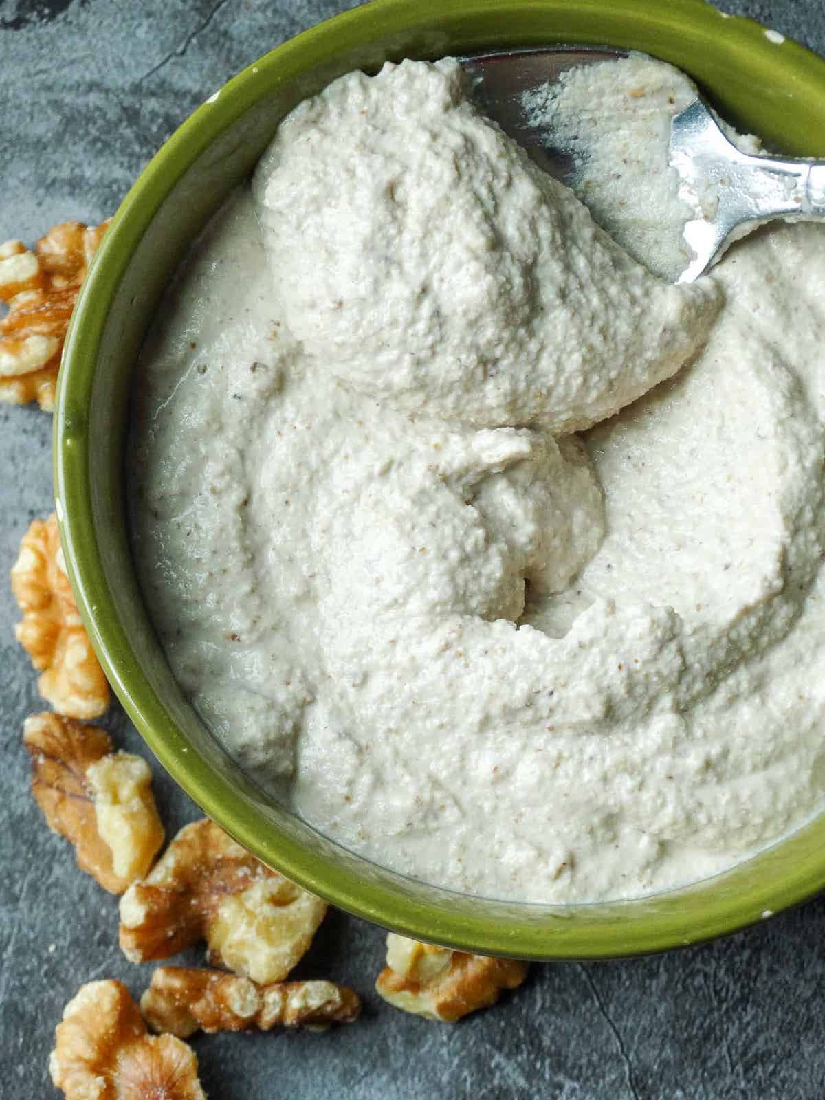 walnut cream sauce in a green bowl