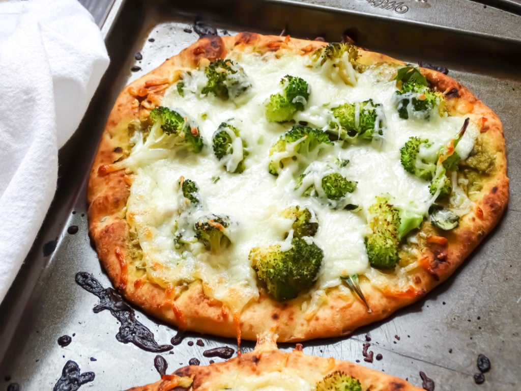 green pizza on a baking sheet
