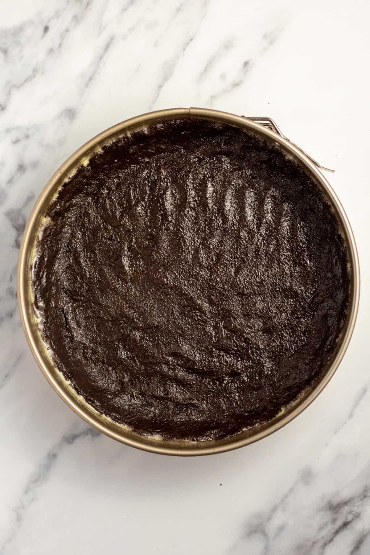a springform pan lined with chocolate oreo crust