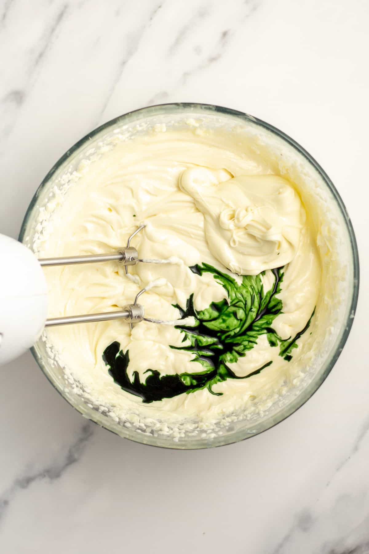 creme de menthe being added to cream cheese batter