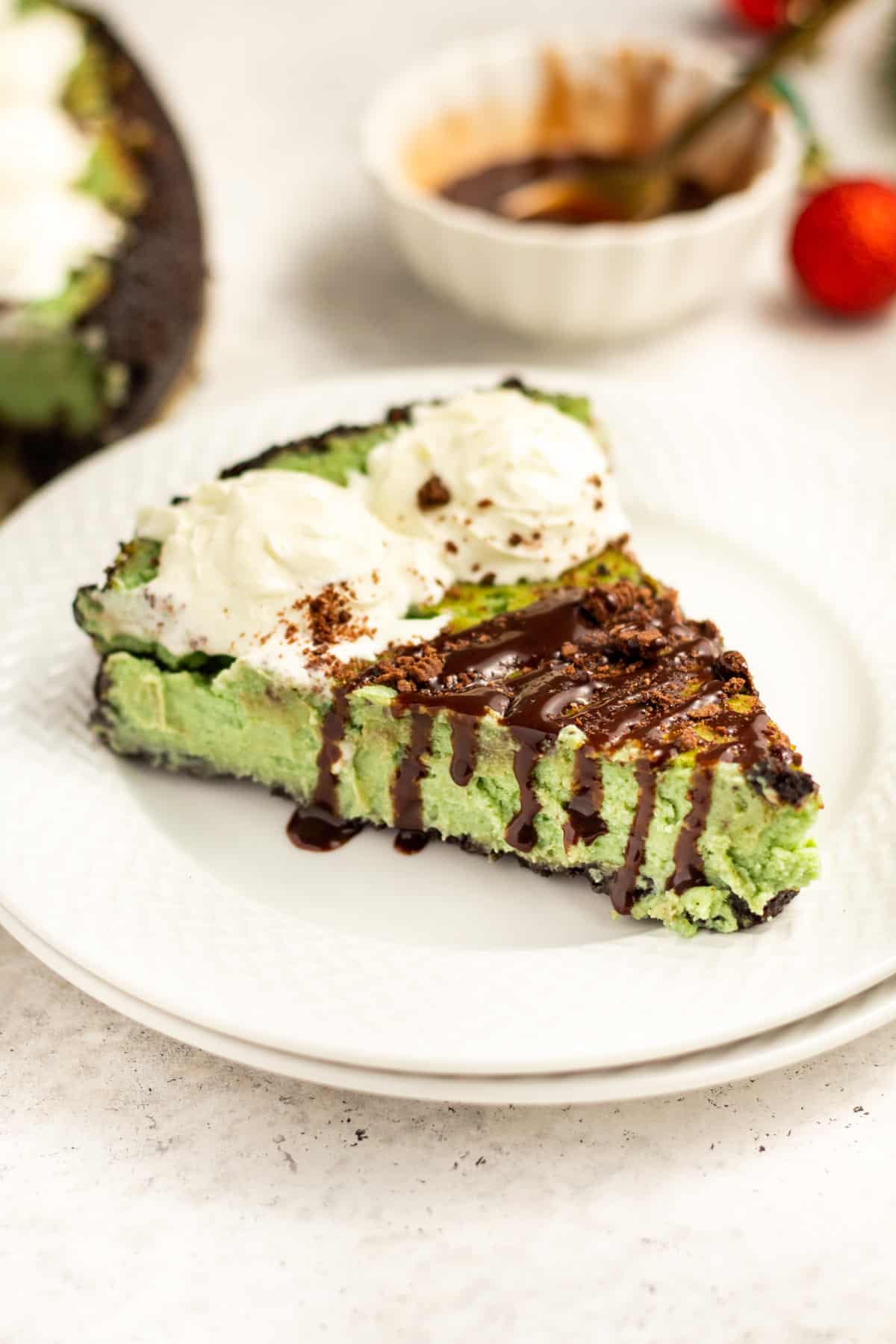 a slice of mint chocolate cheesecake on a white plate