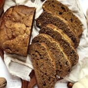 sliced pumpkin bread on a cheesecloth and wooden cutting board