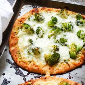 flatbread topped with pesto, arugula and broccoli