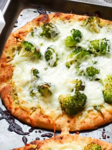 flatbread topped with pesto, arugula and broccoli