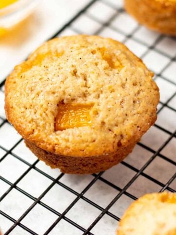 peach muffin on a cooling rack