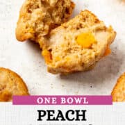 sliced open ginger peach muffin on a white background