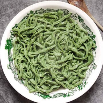 bread machine spinach pasta dough in a white bowl