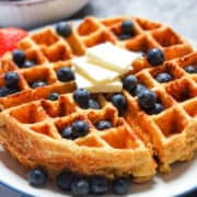 cottage cheese waffles on a plate with fruit and butter
