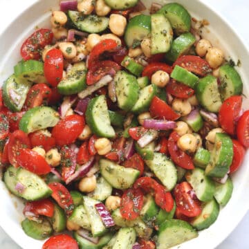 tomato cucumber salad in a white bowl