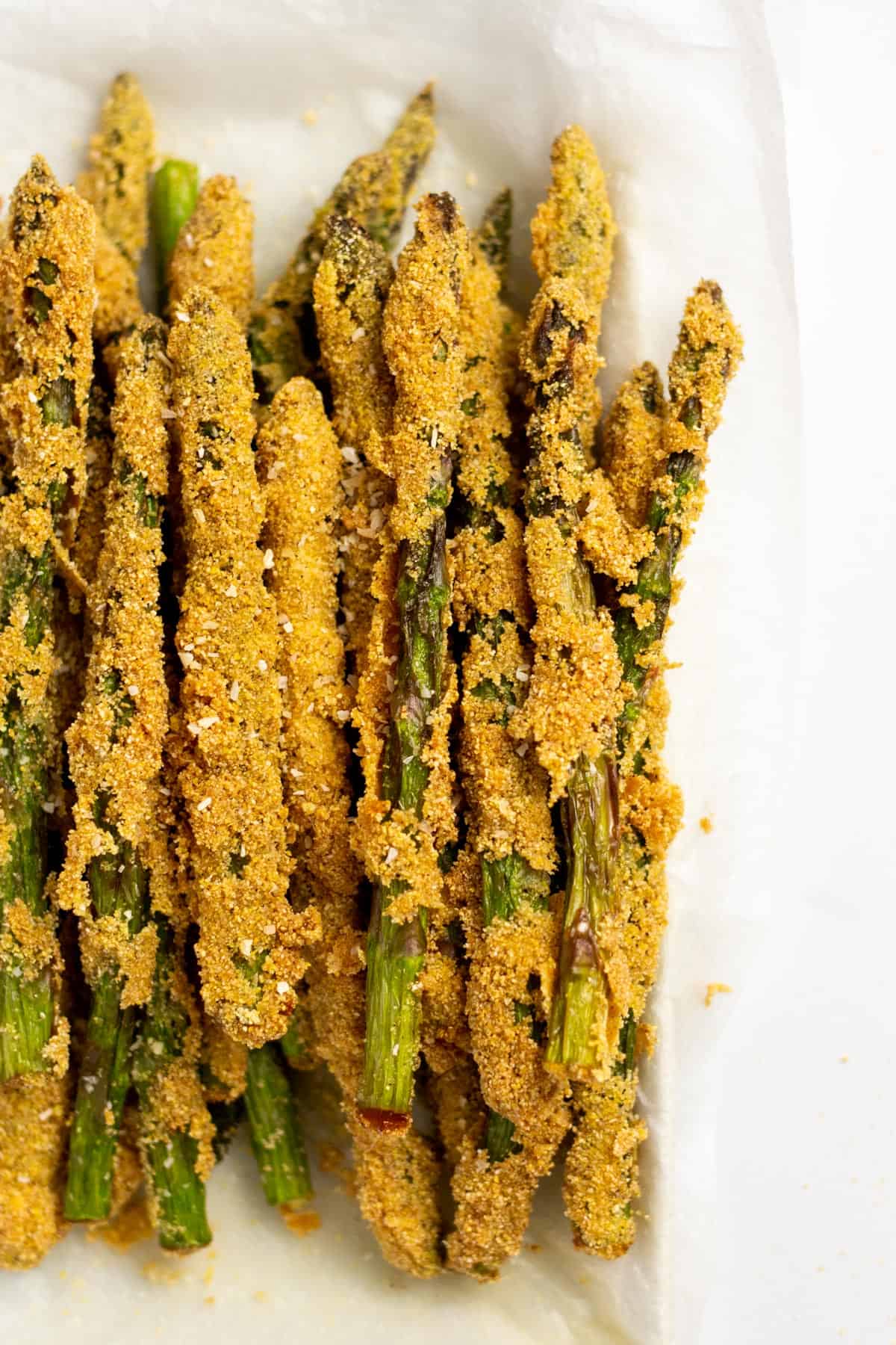 close up of fried asparagus on a white plate