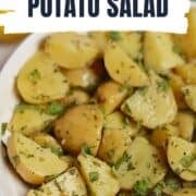 syrian potato salad in a white bowl