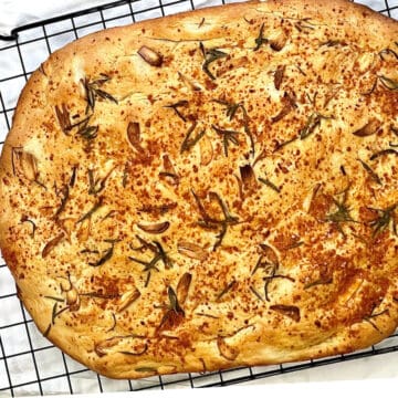 rosemary garlic focaccia bread on a cooling rack