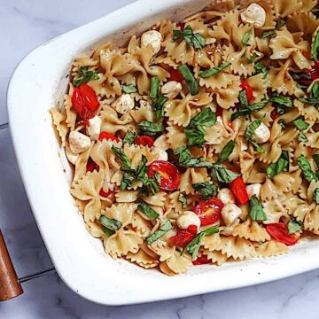 caprese pasta salad in a white serving dish