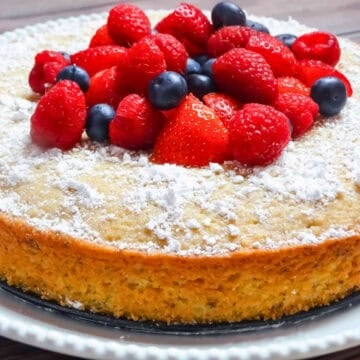 lemon olive cake topped with strawberry and blueberry